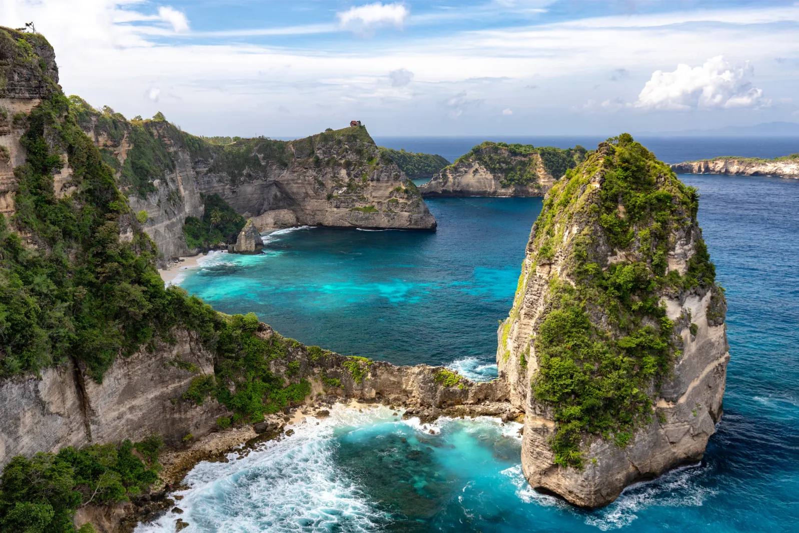 Rocky tropical coastline and blue water in Bali