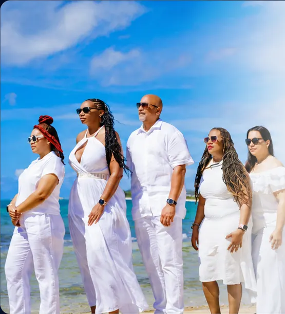 Five LDTG Insiders dressed in white together beside the ocean