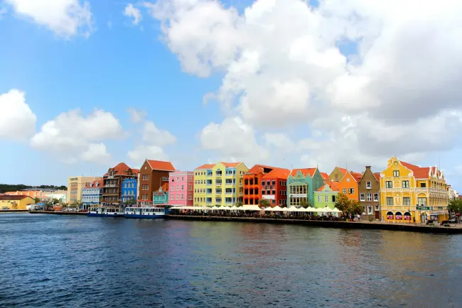 Colorful Willemstad waterfront architecture beside turquoise water in Curaçao
