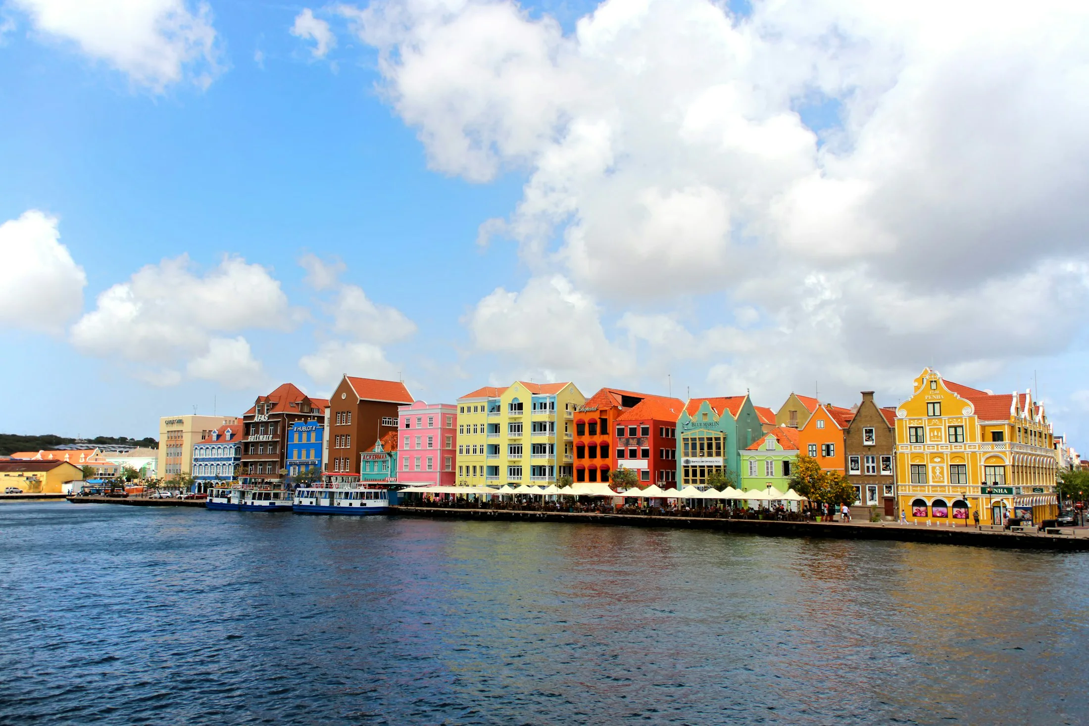 Colorful Willemstad waterfront architecture beside turquoise water in Curaçao